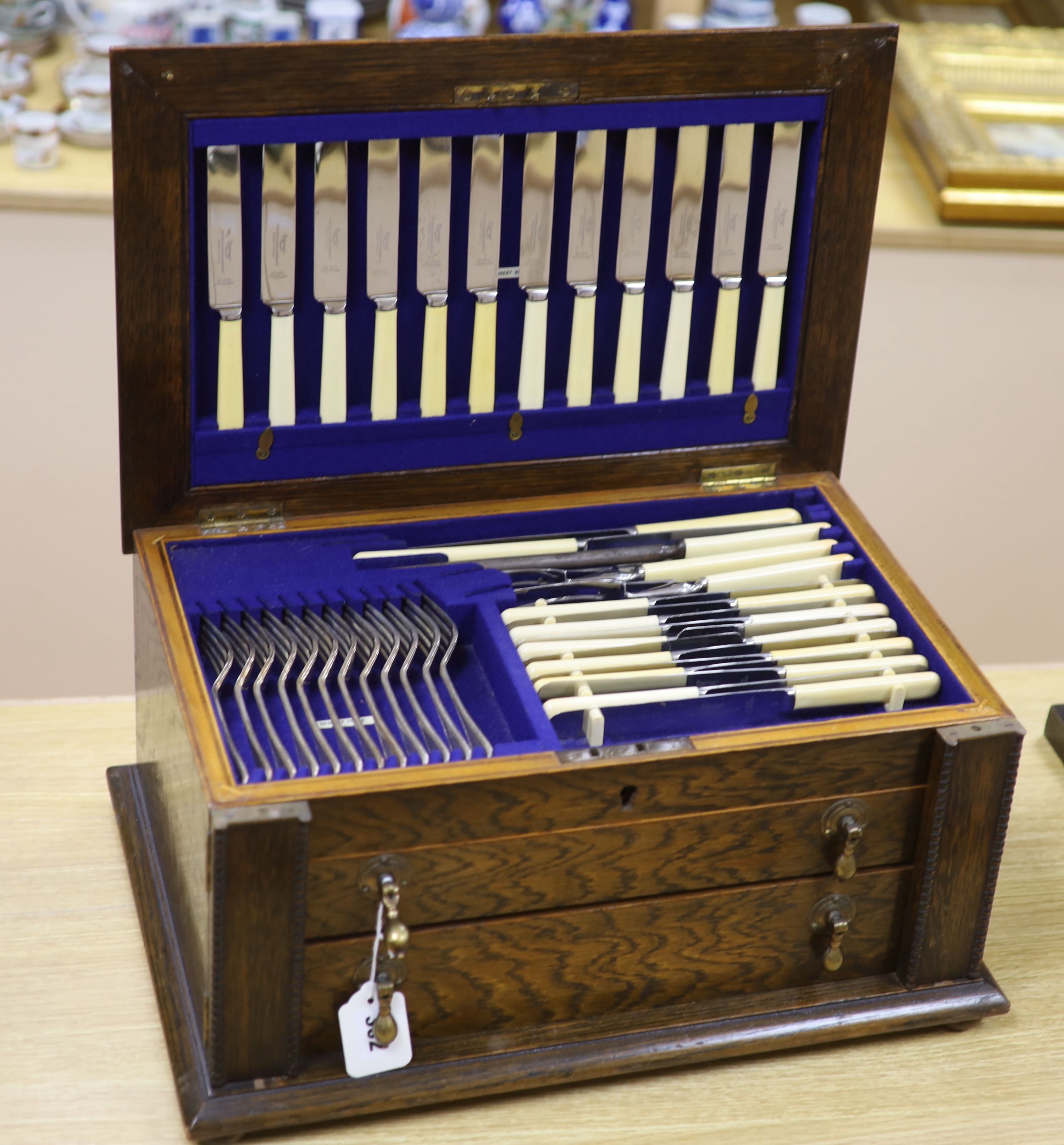 An early 20th century James Dixon oak cased silver plated canteen for twelve